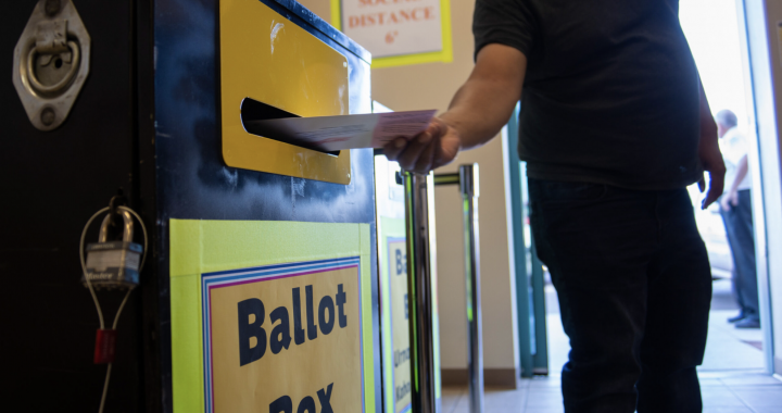 A voter turns in their mail-in ballot at the Clark County Election Department in North Las Vegas on Monday, Oct. 12, 2020. (Daniel Clark/The Nevada Independent)